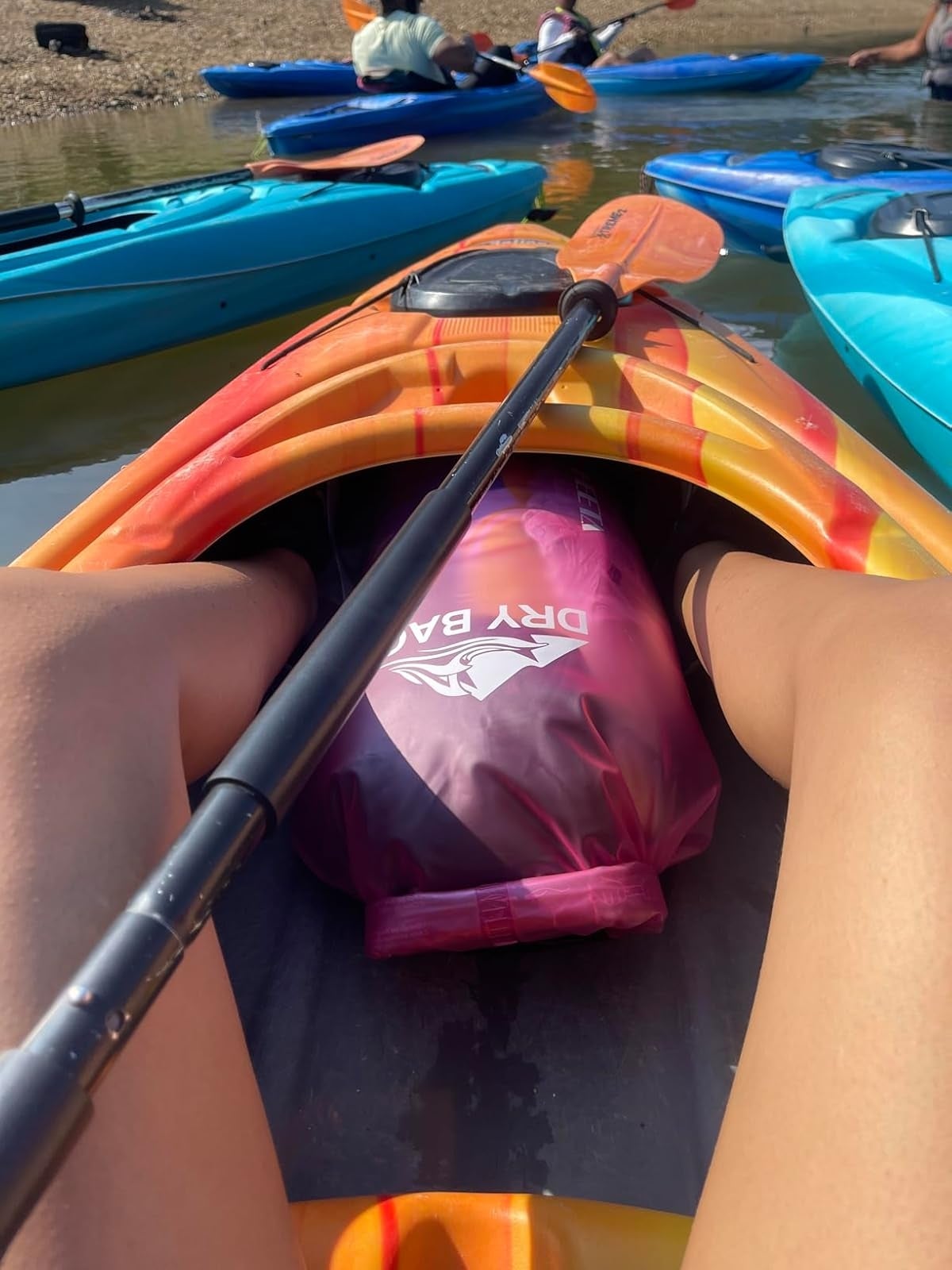 View from a kayak showing a adust  container  betwixt  the reviewer's legs