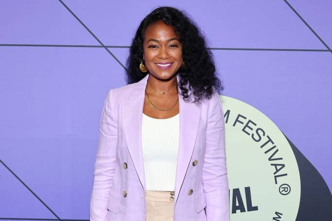 Person successful a stylish blazer and wide-legged pants poses astatine a movie festival event