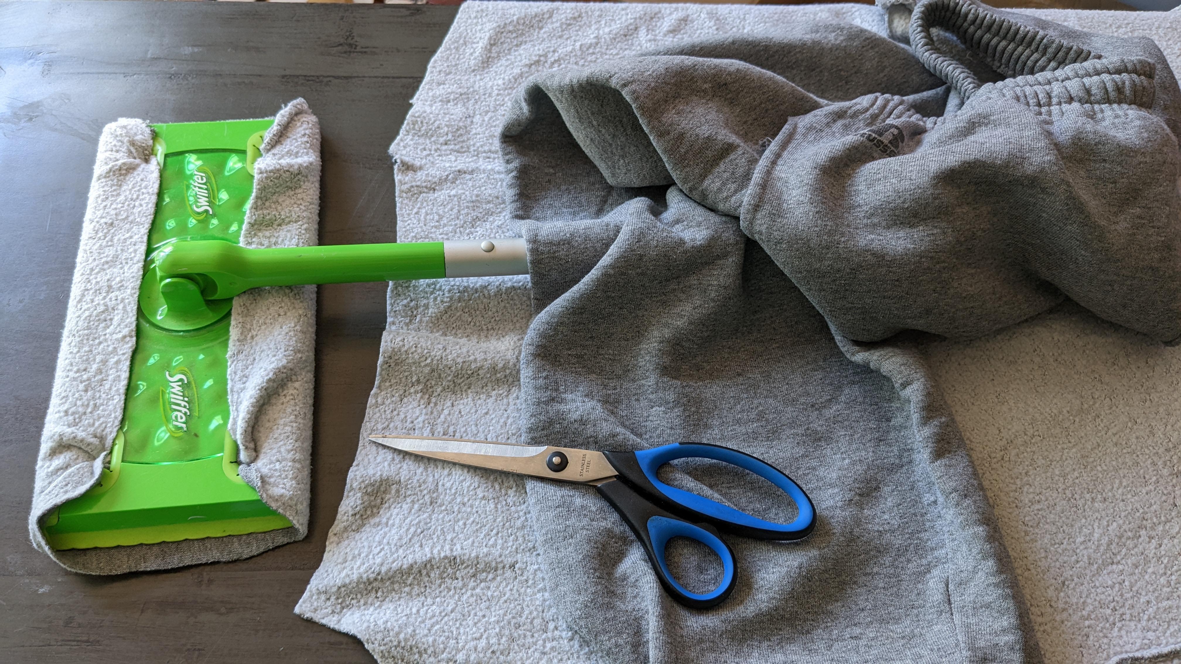 Scissors on fabric with a mop and sweatpants, suggesting a DIY cleaning cloth project for cost-saving ideas