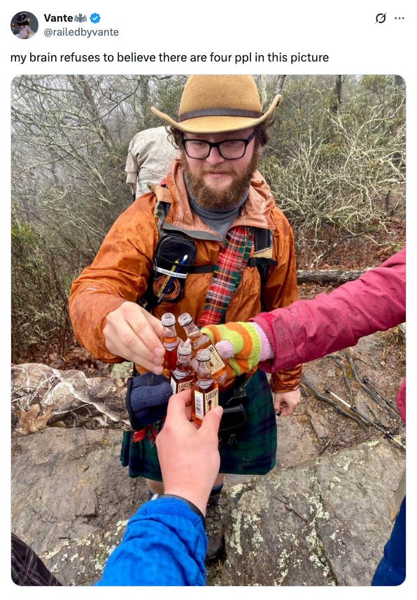 Group of 4  radical   toasting tiny  bottles outdoors; 1  wearing colorful mittens successful  the foreground. Caption jokes astir  disbelief of 4  radical   present
