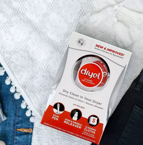 Flat lay of Dryel at-home dry-cleaner kit on jeans and a white top, with shoes. Text highlights Dryel&#x27;s quick, freshening benefits