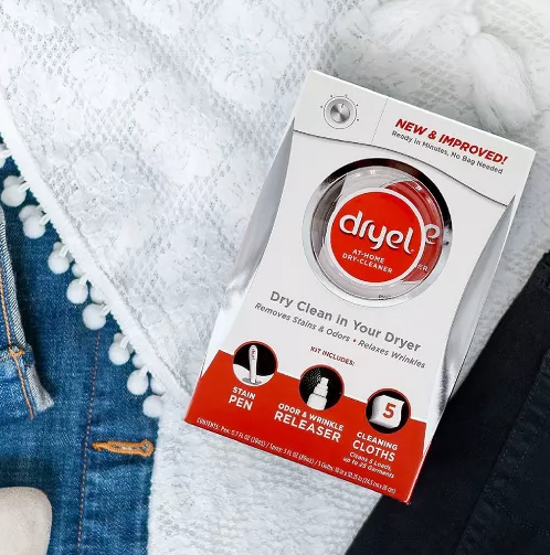 Flat lay of Dryel at-home dry-cleaner kit on jeans and a white top, with shoes. Text highlights Dryel's quick, freshening benefits