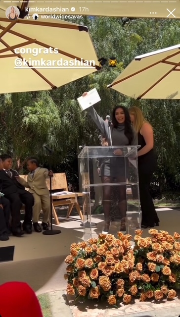 Kim Kardashian excitedly holds up her diploma during her law school graduation