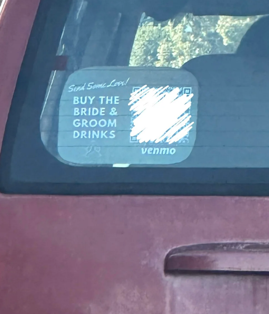 Sign in car window reads, "Send some love! Buy the bride & groom drinks," followed by a QR code and Venmo username