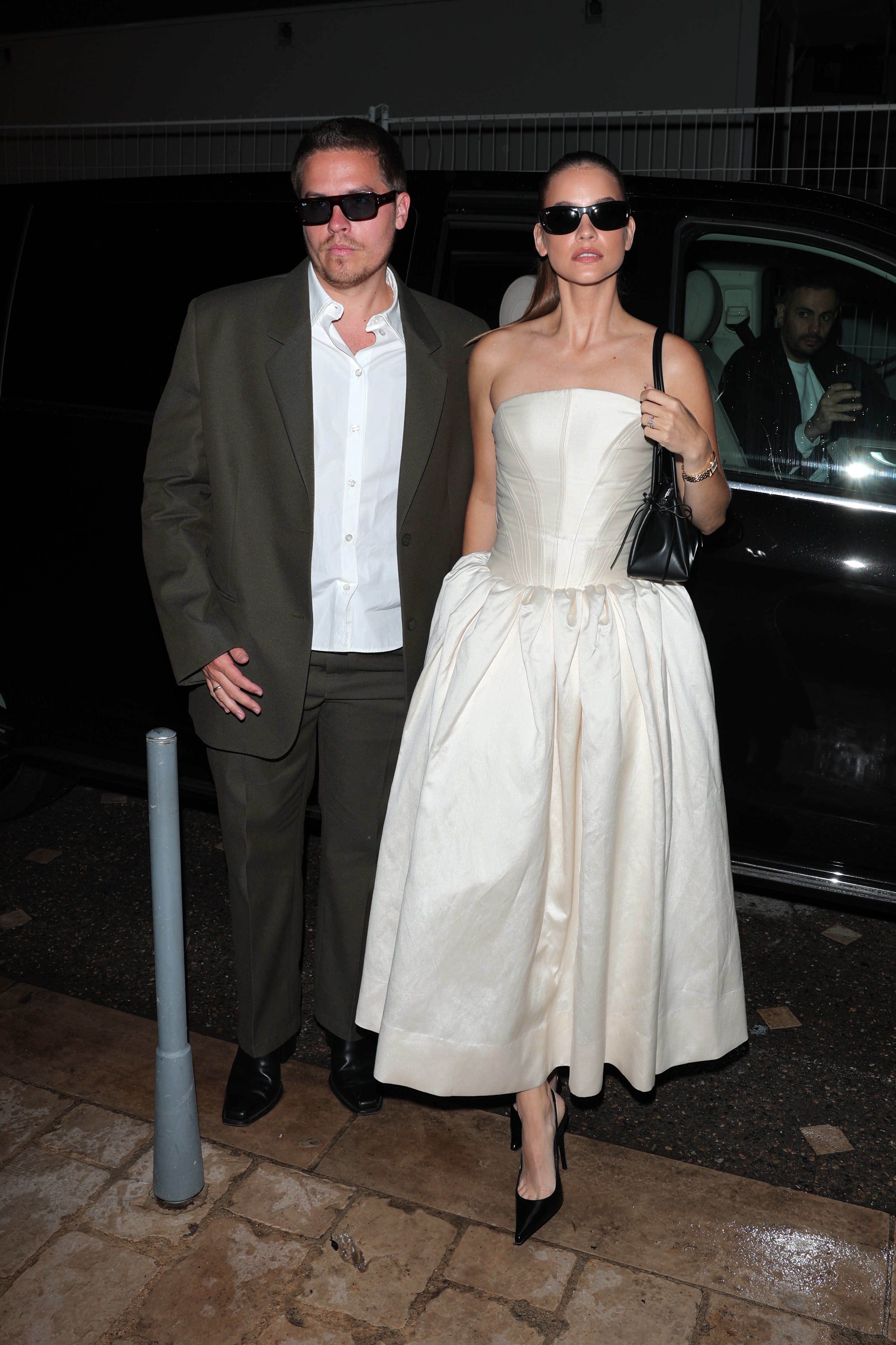 Dylan Sprouse and Barbara Palvin exiting a car dressed in formal attire
