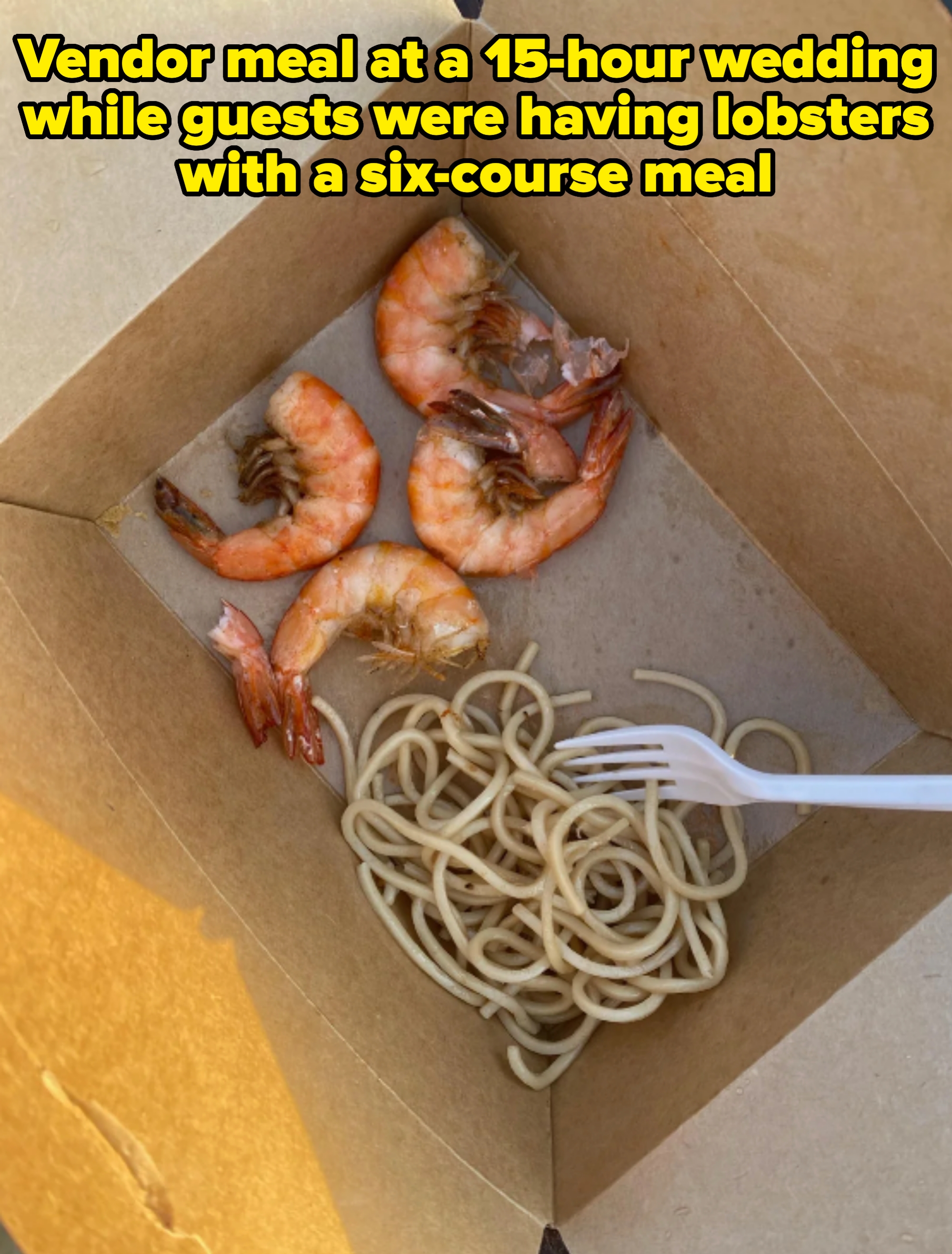 Five cooked shrimp and a portion of plain noodles with a disposable fork in a takeout box