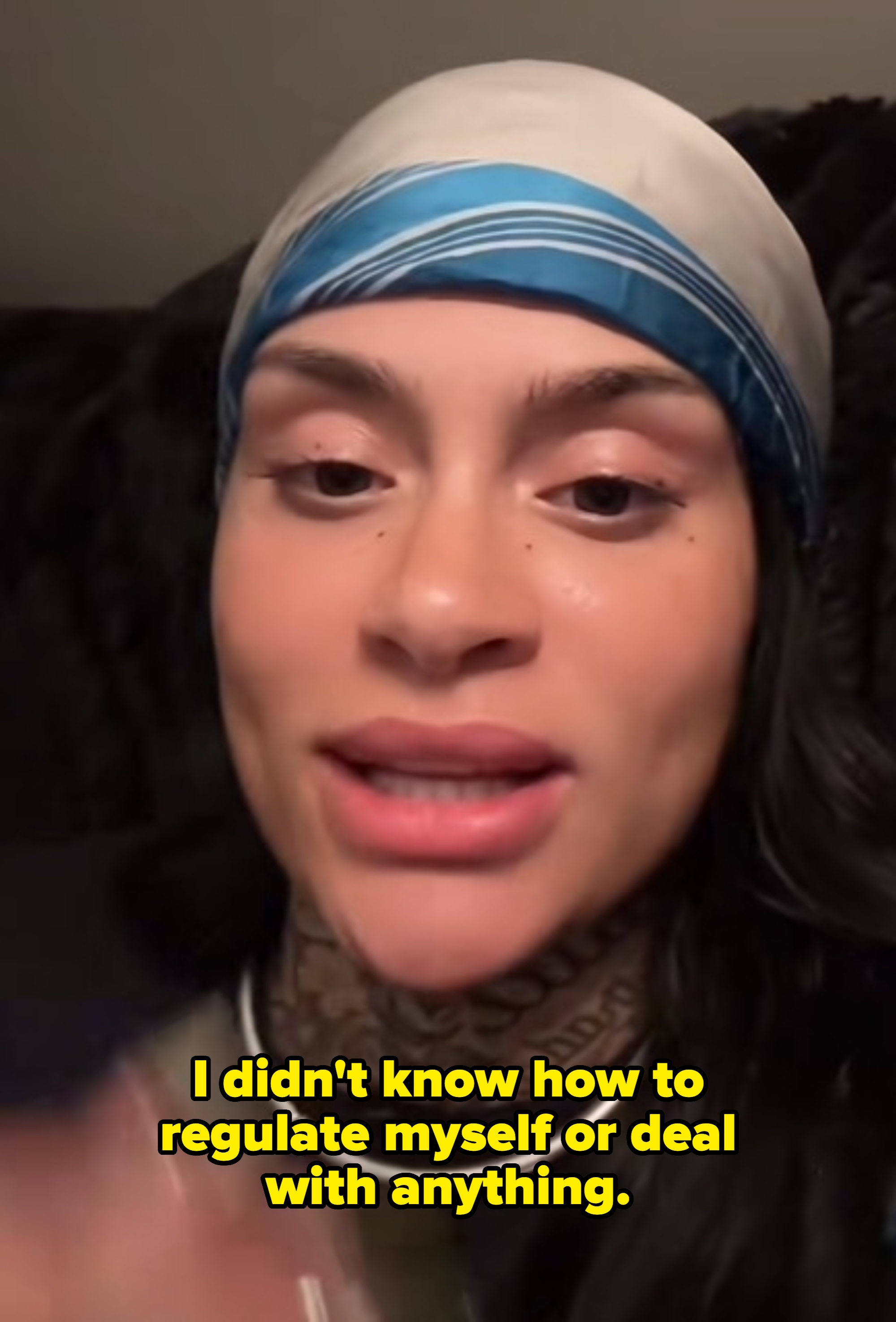 Kehlani with a headscarf and tattoos appears relaxed in a close-up shot