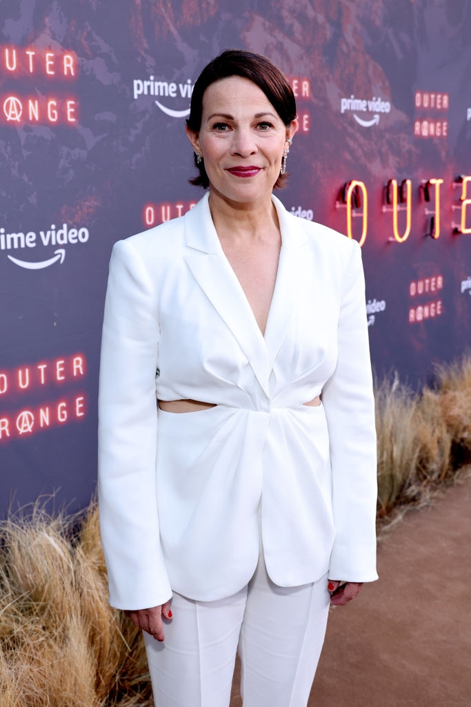 Lili on red carpet in a cut-out suit