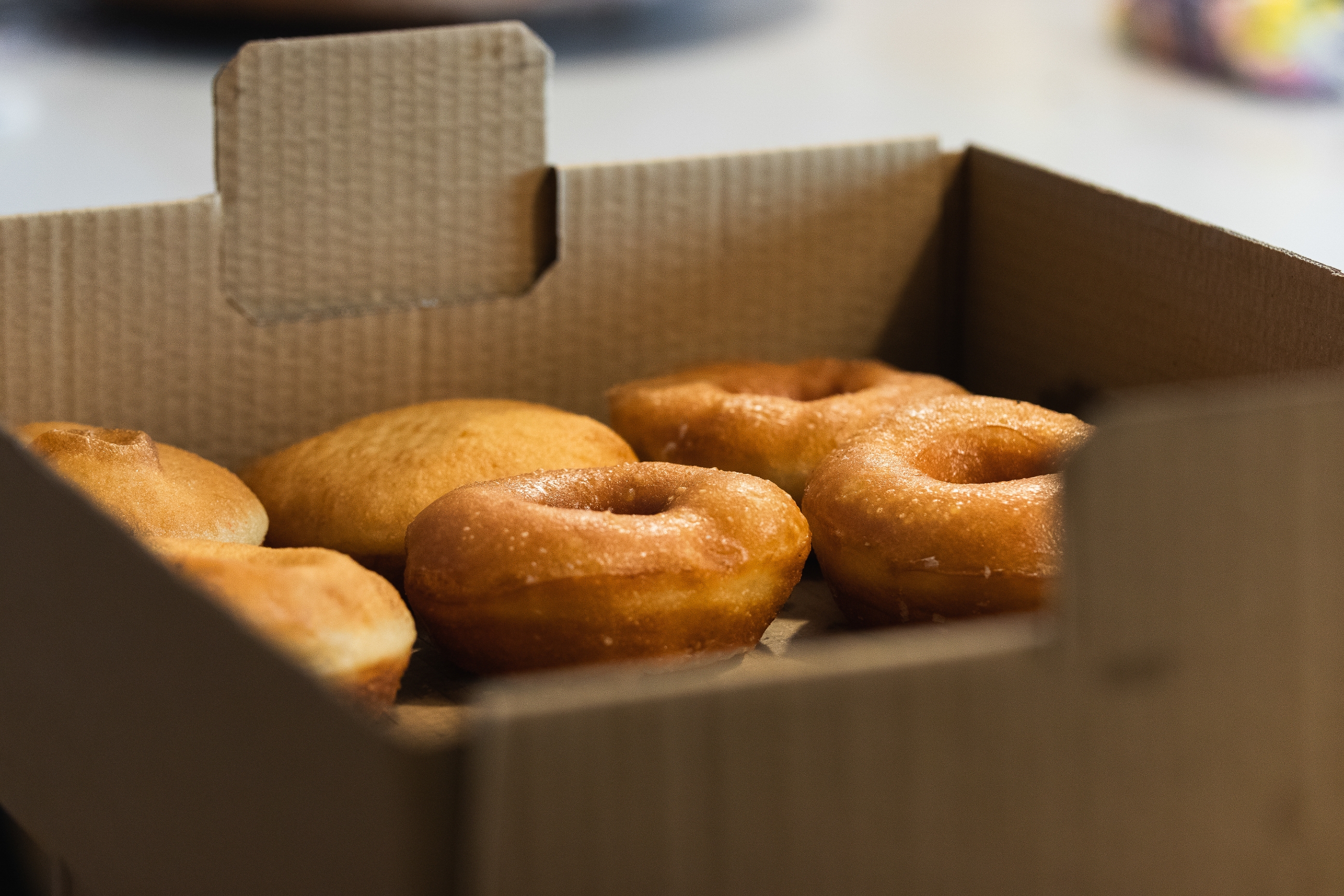 Box of assorted donuts and muffins on a table