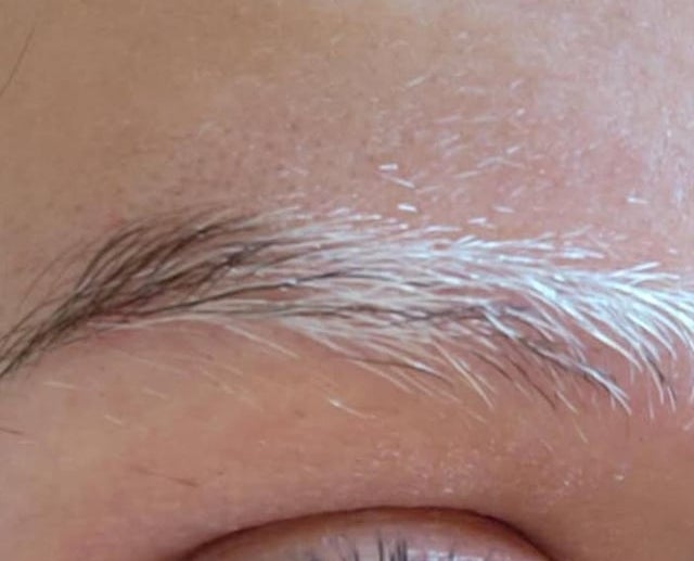 Close-up of a person's eye looking upwards, visible eyelashes and brow