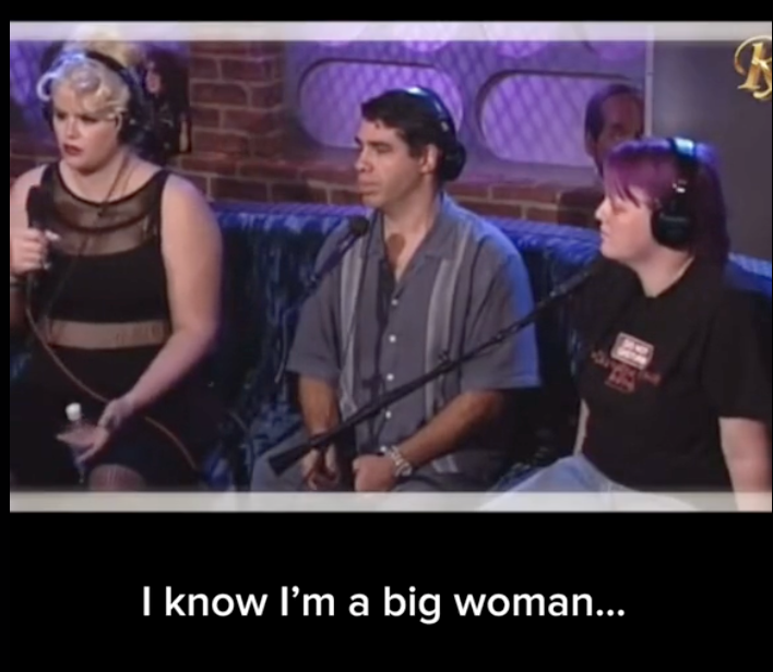 Three people seated with microphones on a talk show set. Text on screen reads: "I know I'm a big woman…"