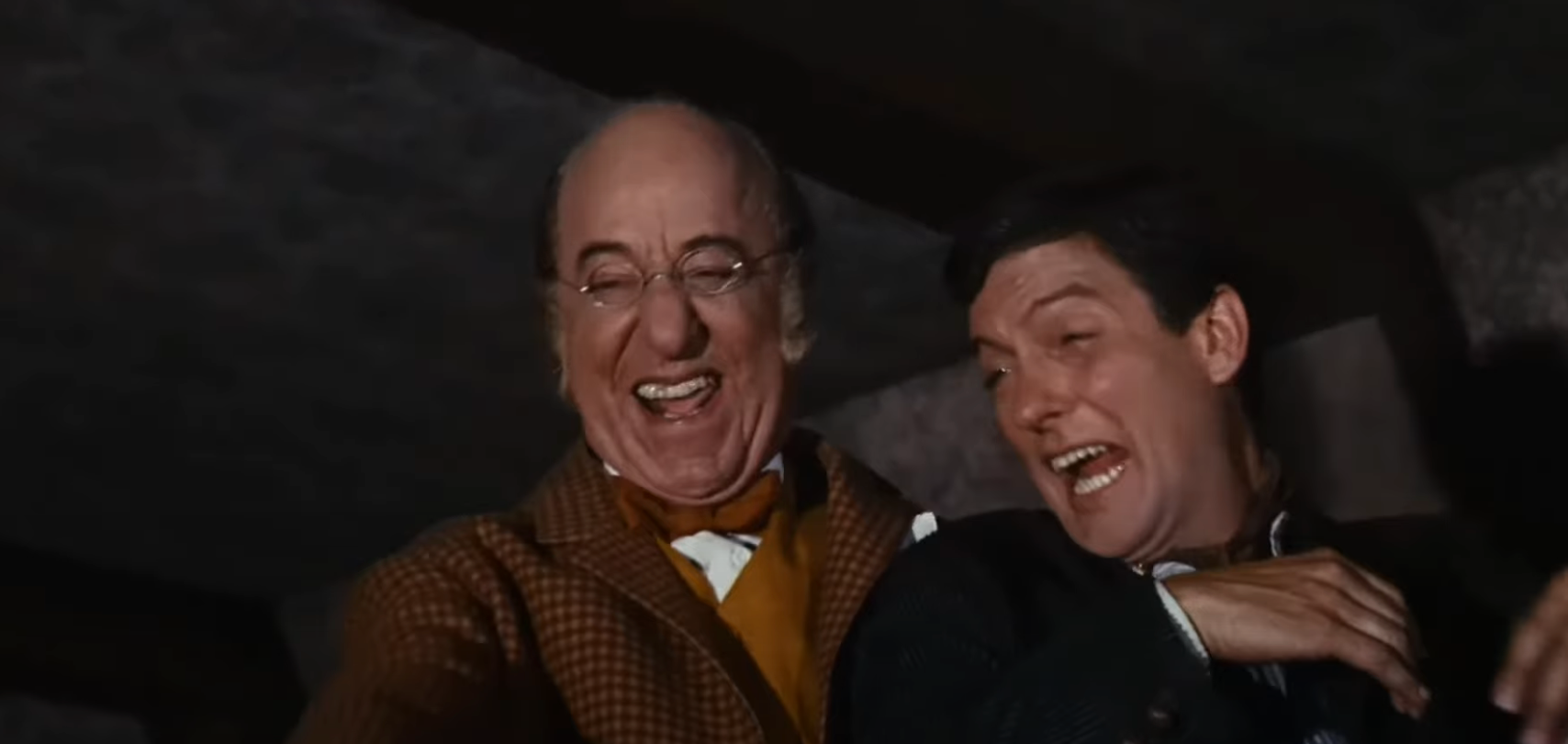 Two men smiling and laughing together in a candid moment