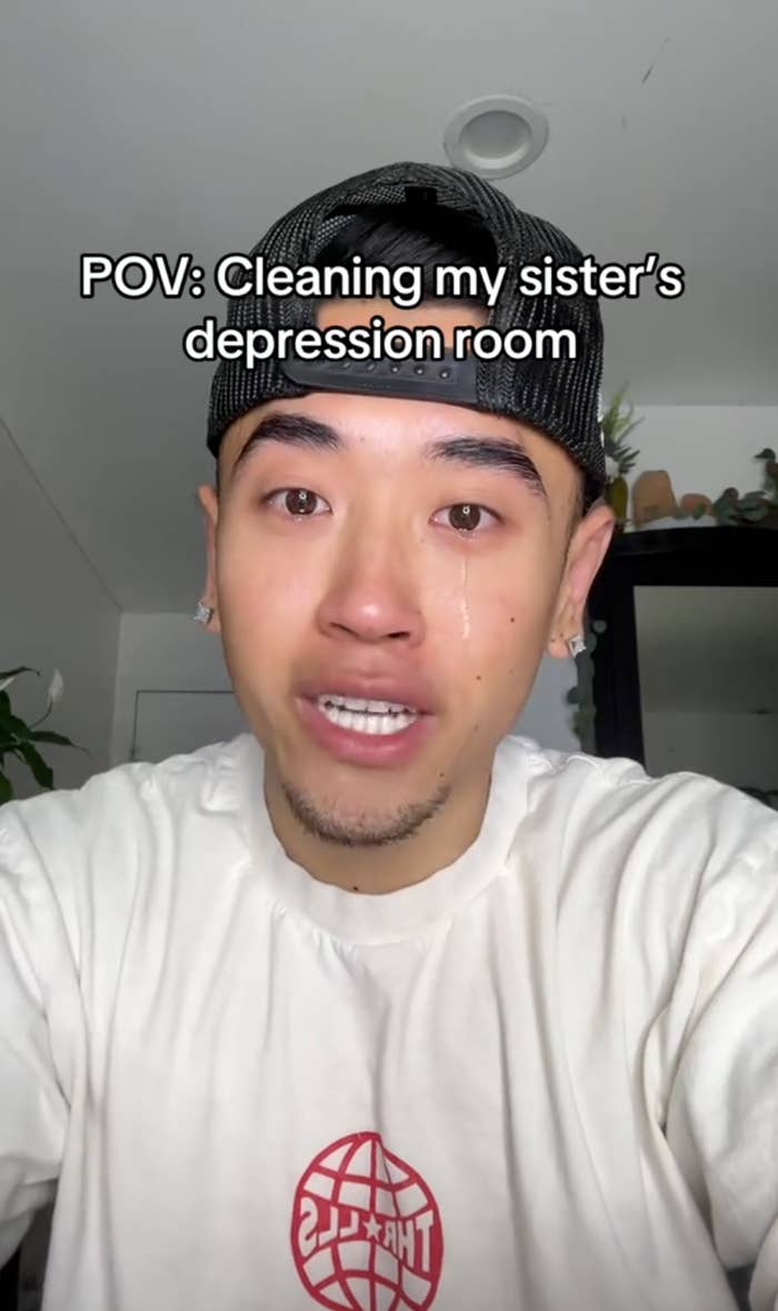 A person wearing a t-shirt and cap talks to the camera with text overlay: "POV: Cleaning my sister's depression room."