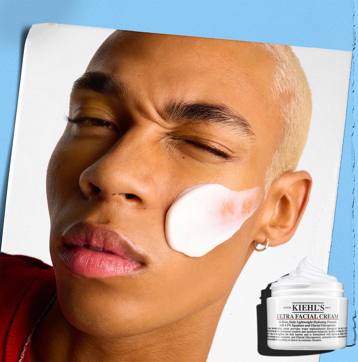 Person with short hair applying Kiehl's Ultra Facial Cream on cheek, showcasing skincare routine