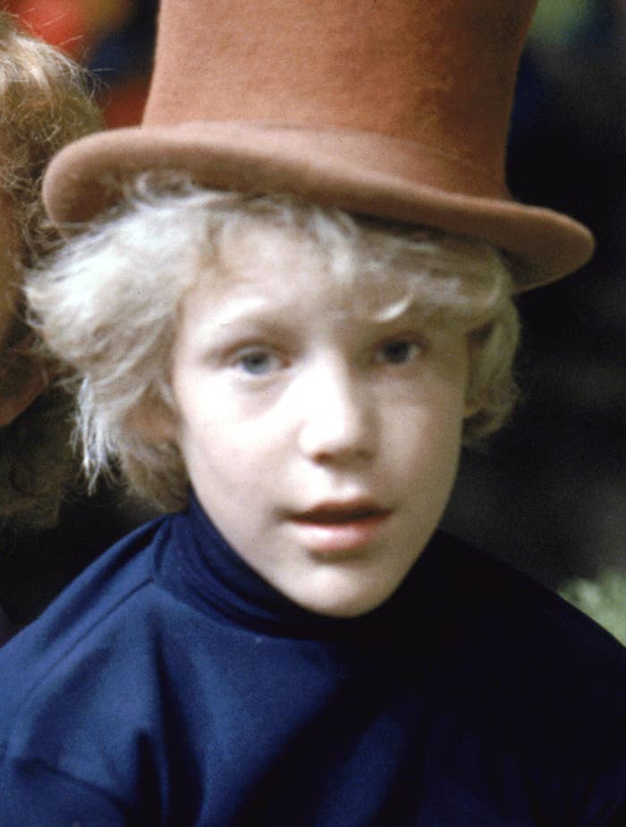 Two characters are shown; the adult wears a vintage-style suit with a bow tie and top hat, the child has curly hair and a curious expression