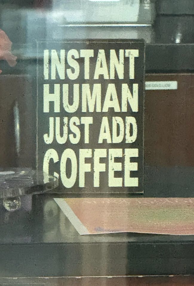 Sign with text: "Instant Human Just Add Coffee."