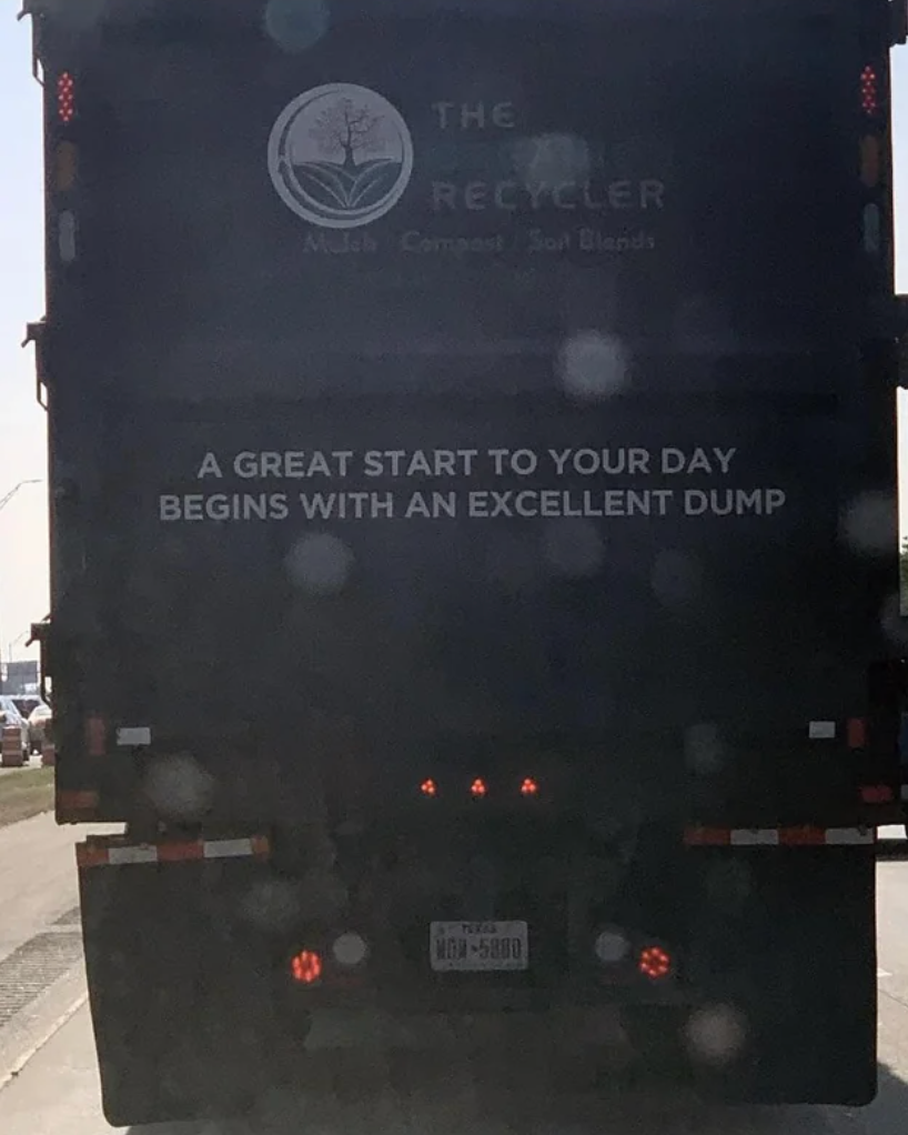 Rear of a recycling truck with humorous text: "A great start to your day begins with an excellent dump."