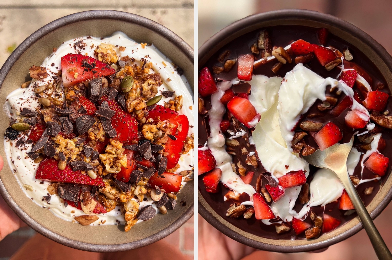 Two bowls of yogurt topped with strawberries, nuts, and chocolate chunks, showcasing a delicious, healthy breakfast or snack option