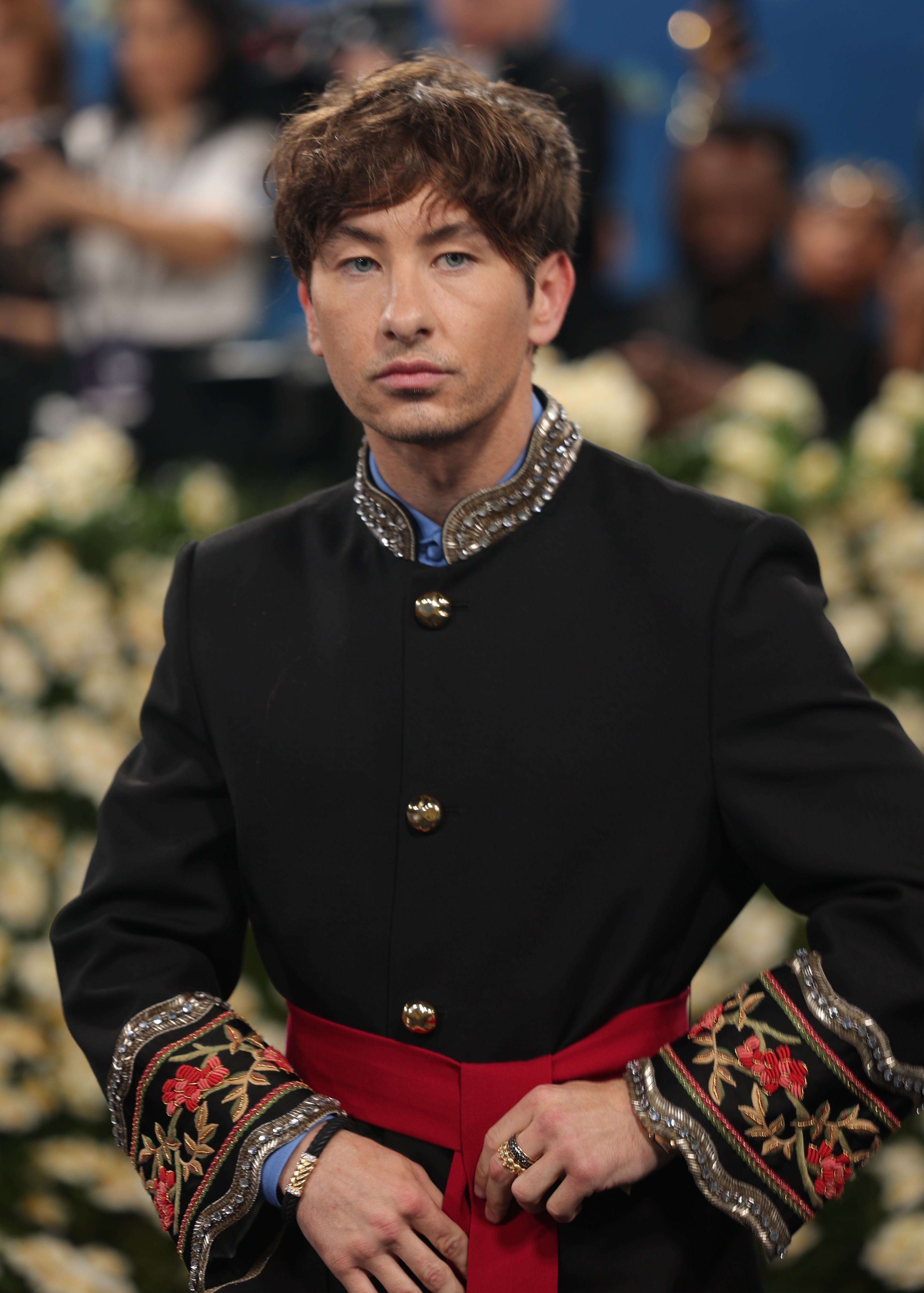 Barry Keoghan in ornate military-inspired jacket with embroidery and a red sash at a formal event