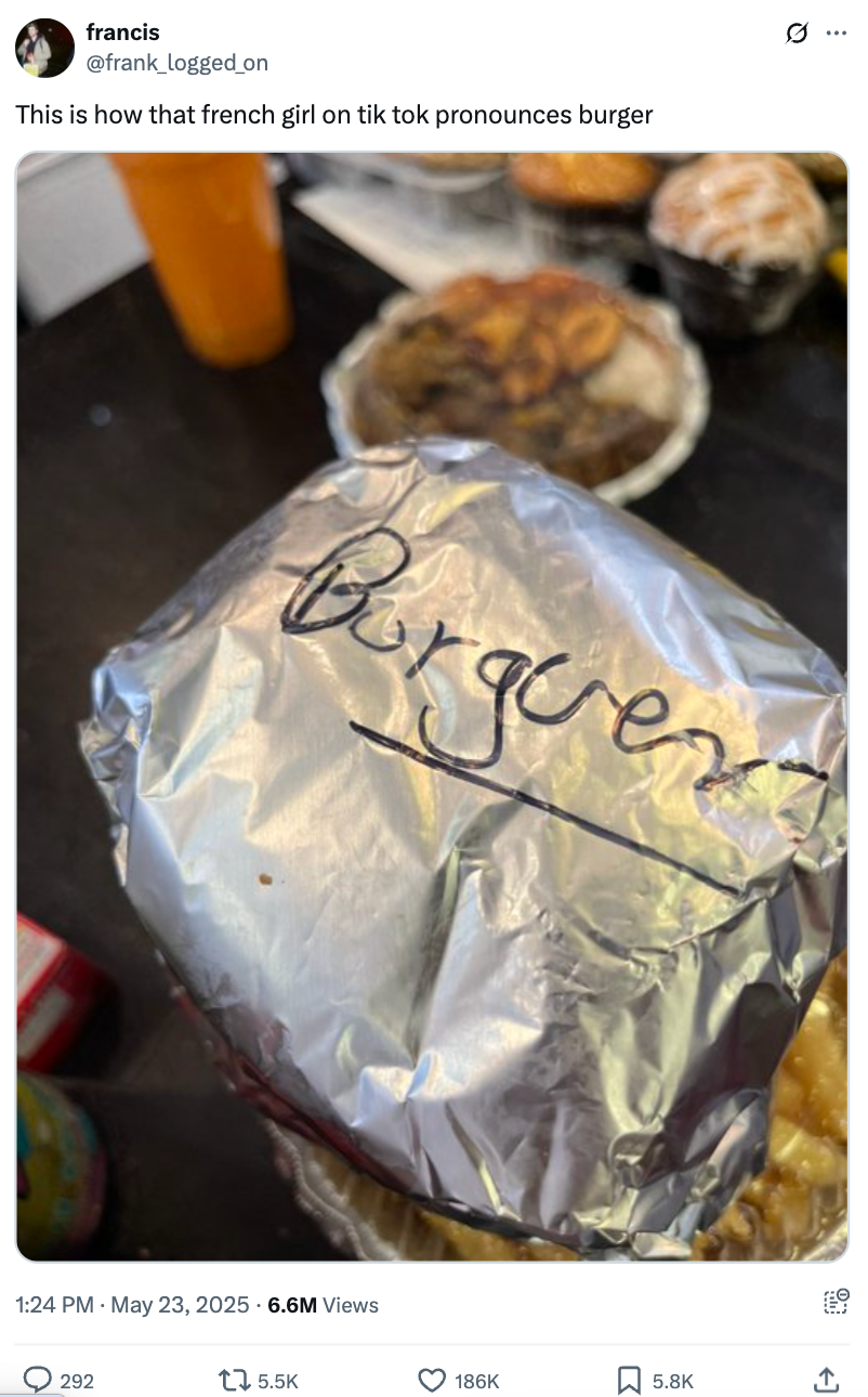 Foil-wrapped burger labeled "Burguer," surrounded by other takeout food items