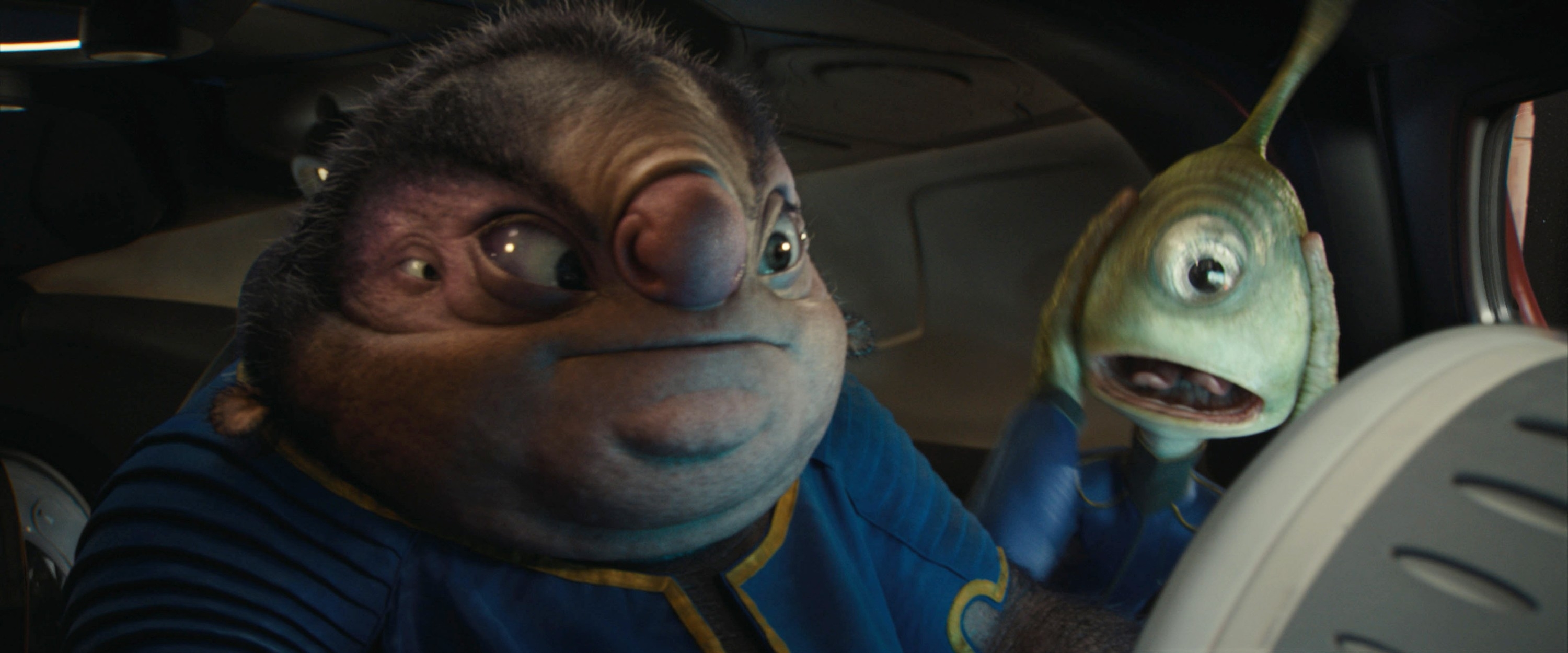 Two animated alien characters in a spaceship, one holding a fish-like creature, both with surprised expressions