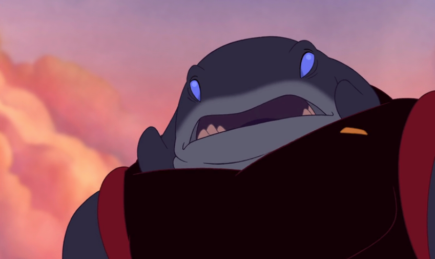 Animated shark-like creature with a wide mouth and glowing eyes, looking upward with a neutral expression
