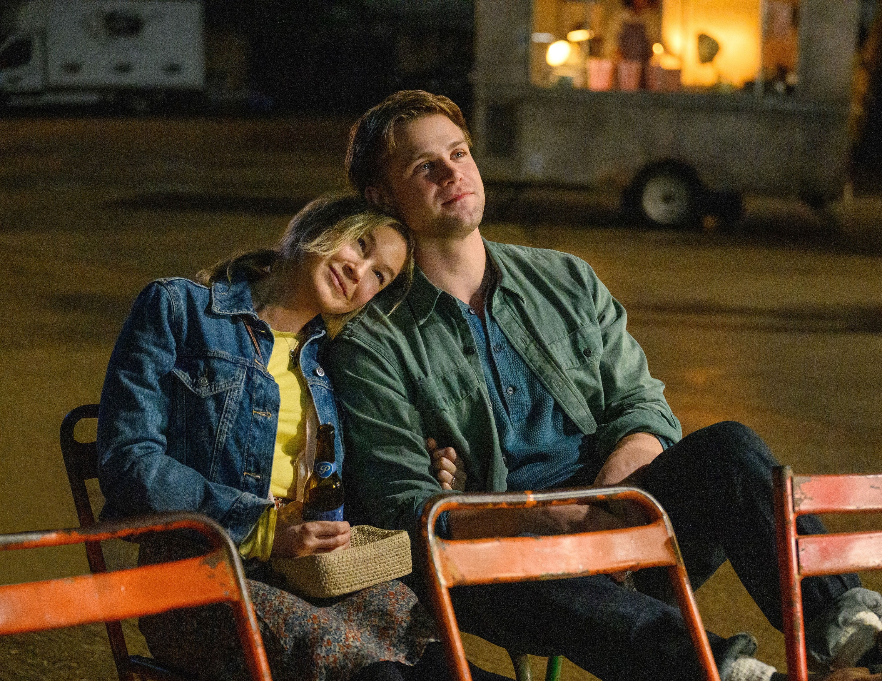 Renee Zellweger and Leo Woodall sitting closely in a scene from "Bridget Jones: Mad About They Boy"