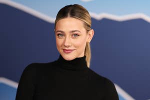 Person with slicked-back hair in a black turtleneck poses against a geometric background