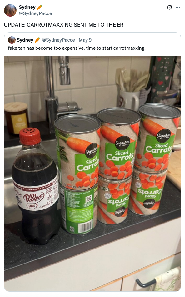 Countertop with four large cans of sliced carrots and a bottle of diet soda. Social media post humorously mentions 'carrotmaxxing' leading to ER visit