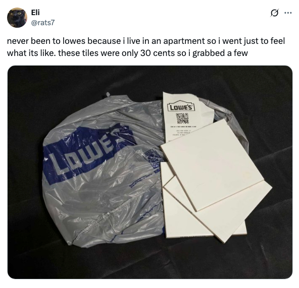 Plastic Lowe's bag with several white tiles and a QR code on one tile. Tweet text discusses visiting Lowe's and buying tiles for 30 cents each