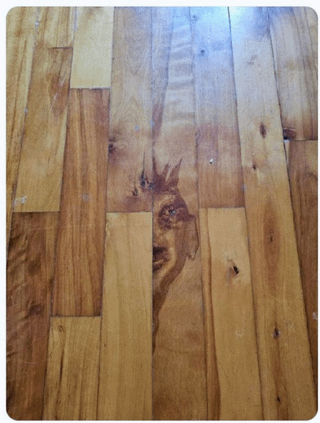 Wood flooring with an interesting pattern resembling a face