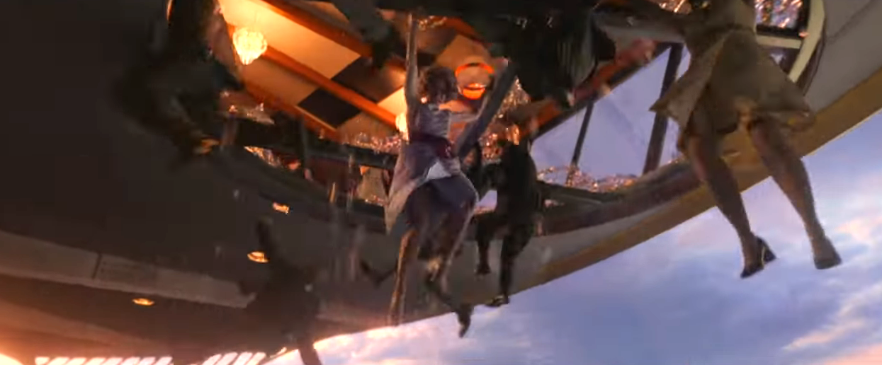 Scene from a sci-fi film with people hanging from the open edge of a spaceship interior, set against a sky backdrop