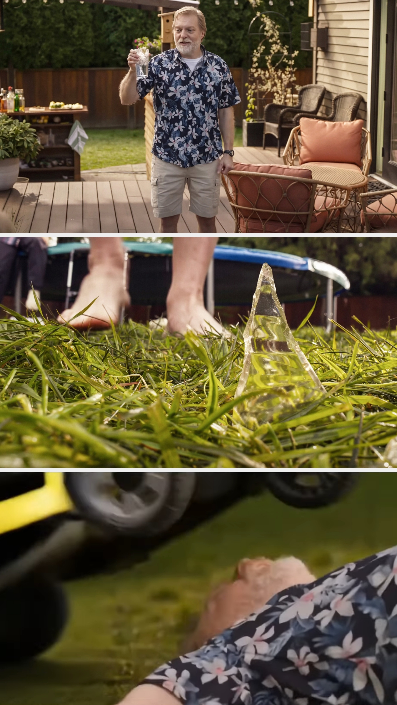 Man in a floral shirt and shorts holding a drink on a lawn. Pyramid crystal on grass. Close-up of a running lawnmower