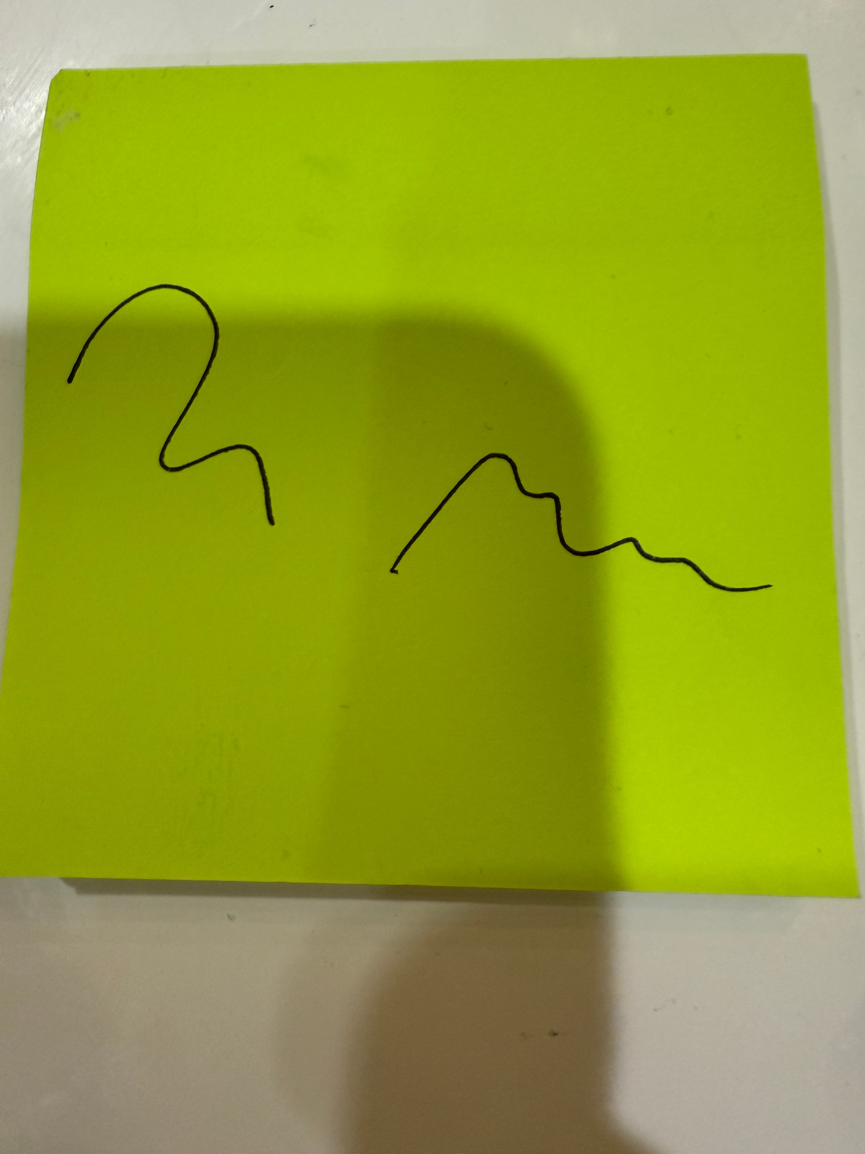 A bright post-it note with an abstract, curved black line sketch