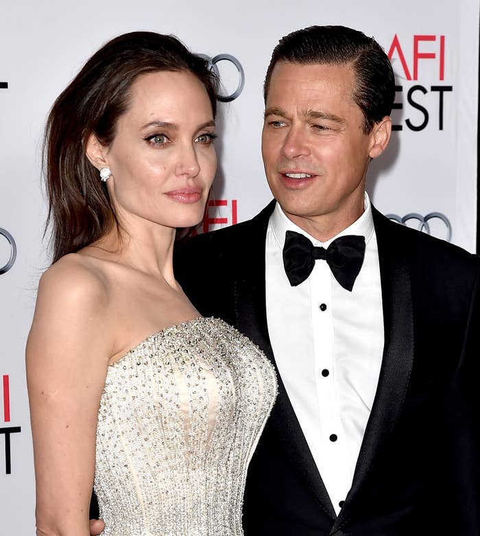 Brad Pitt and Angelina Jolie on a red carpet event. One is wearing a sparkling strapless gown, and the other is in a classic tuxedo