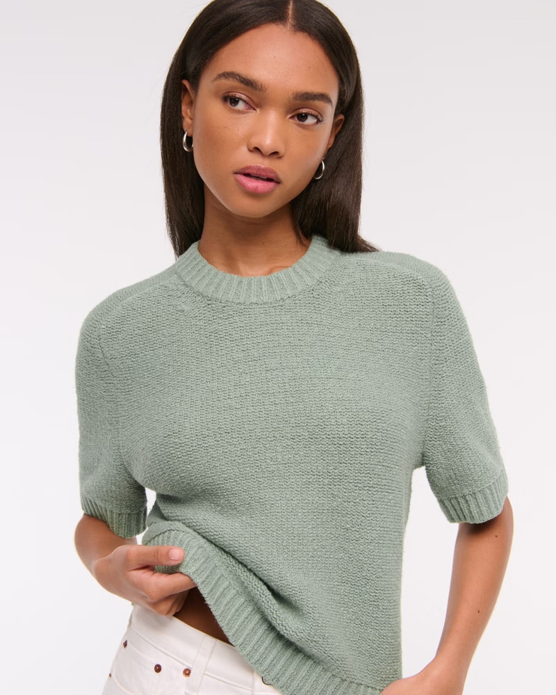Model wearing the green sweater tee