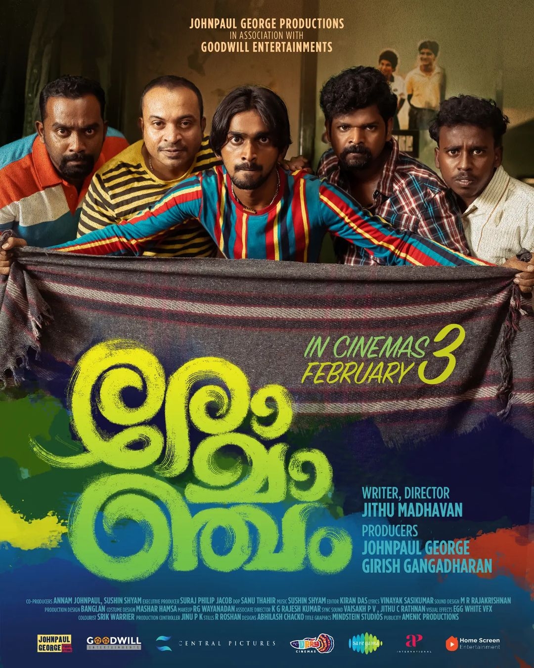A movie poster with five men holding a colorful blanket. Text says βIn cinemas February 3.β Writer, director: Jithu Madhavan