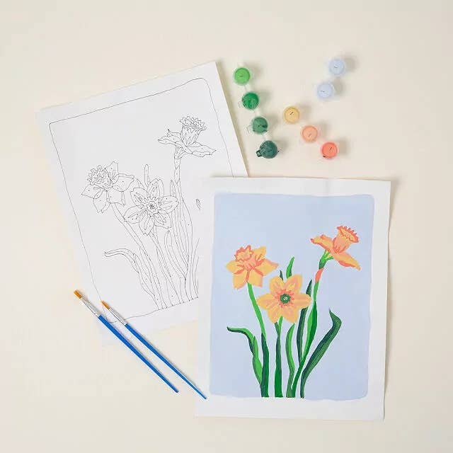 Paint-by-numbers kit with a daffodil design. Includes outlined canvas, paint pots, and brushes, ideal for crafting enthusiasts