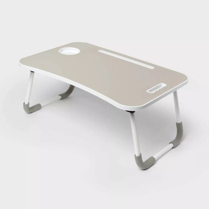 Portable thigh table with collapsible legs, cupful holder, and tablet slot