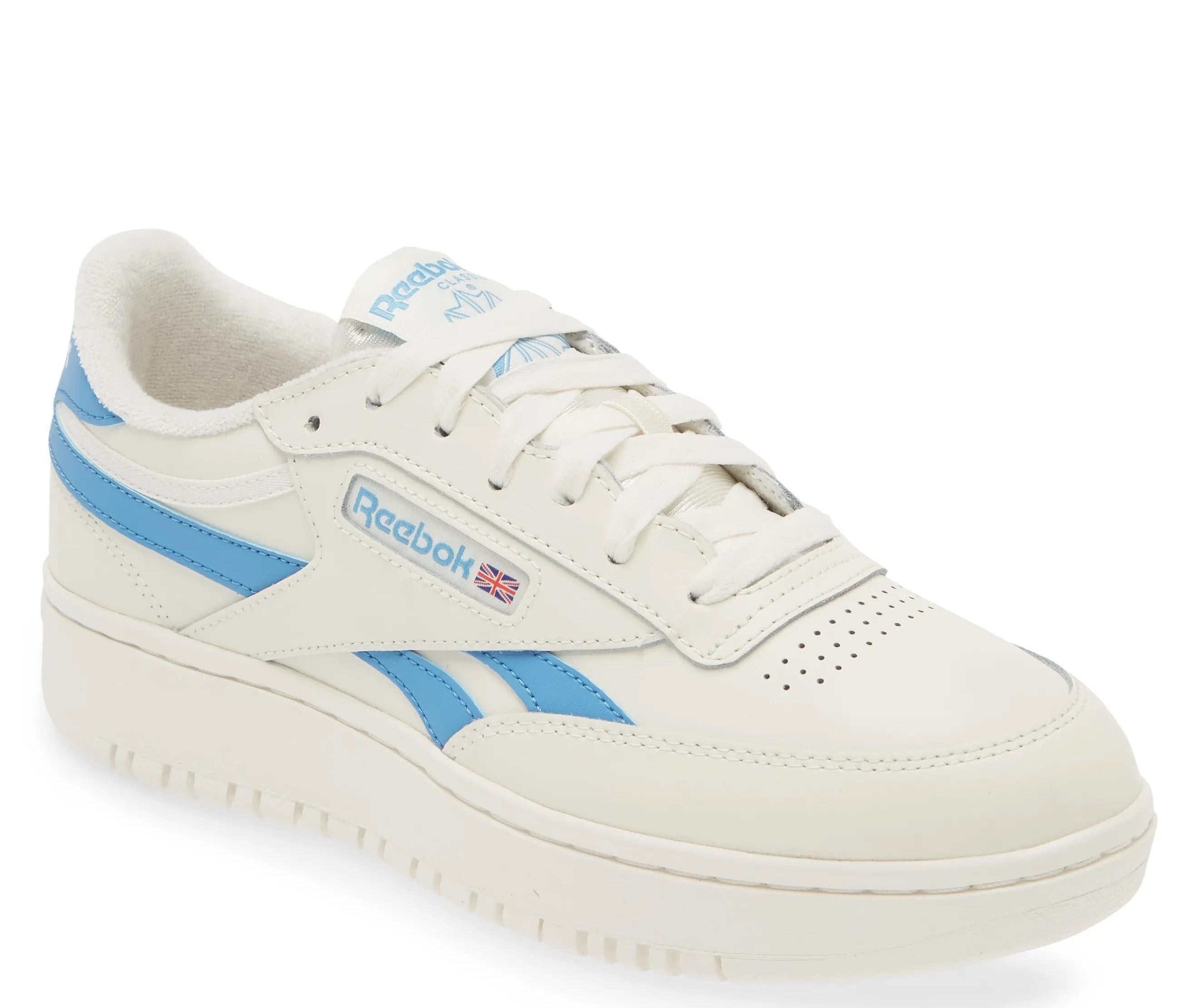 Reebok sneaker with blue accents, platform sole, and logo on side, positioned for a shopping article
