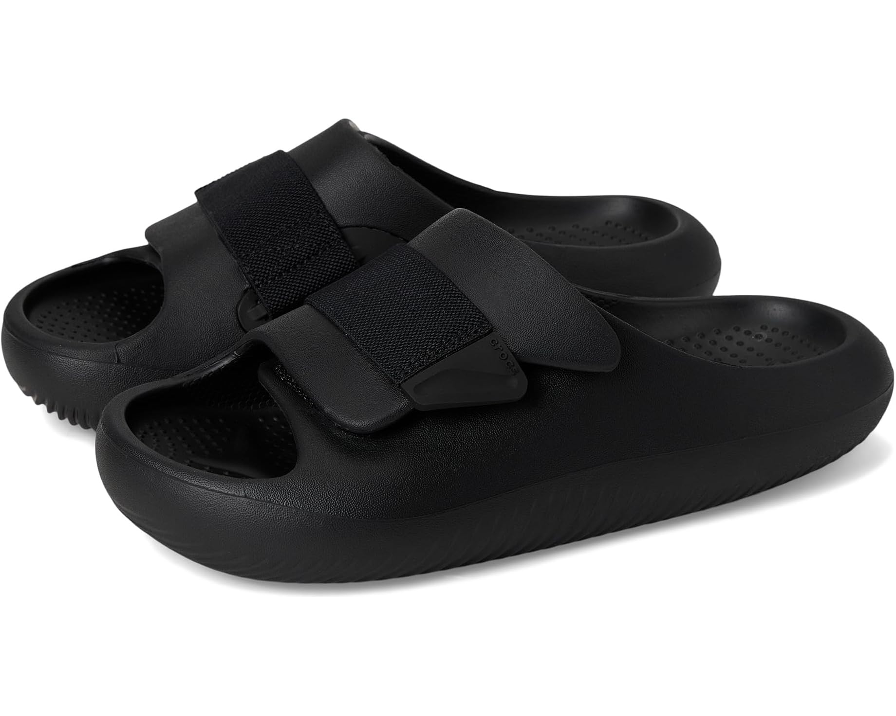 A pair of black slip-on sandals with adjustable straps and textured soles, perfect for casual wear