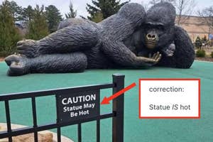 Large gorilla statue lies on grass with a sign saying "CAUTION Statue May Be Hot." Correction note reads "Statue IS hot."