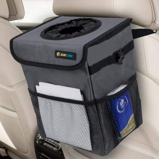 Car trash bin with pockets attached to the back of a seat, designed for organizing waste and storing small items for convenience while traveling