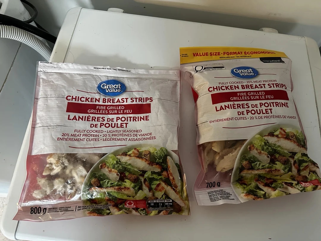 Packages of Great Value chicken breast strips on a washing machine