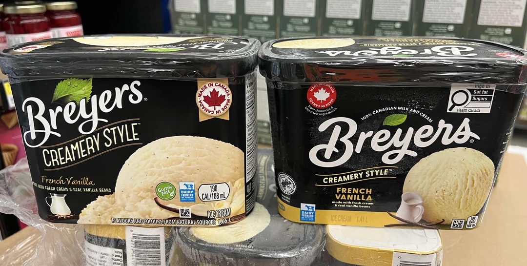Two tubs of Breyers Creamery Style French Vanilla ice cream displayed in a store, with visible branding and nutritional labels