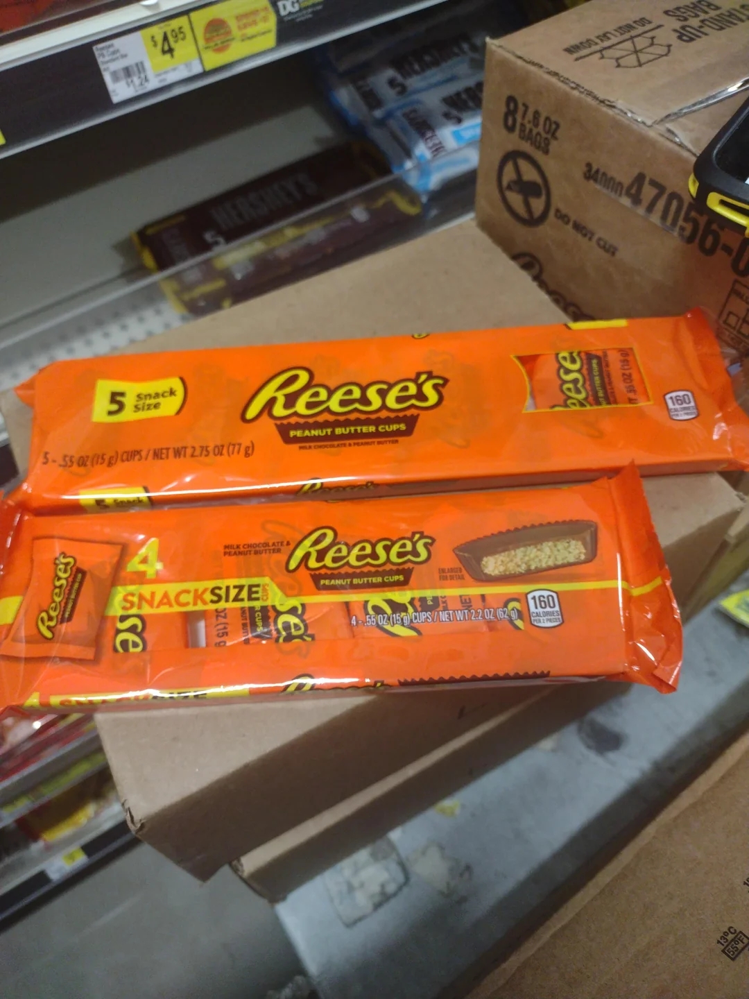 Two packs of Reese&#x27;s Peanut Butter Cups, one with 5 snack-size pieces, displayed on a store shelf