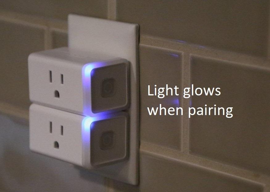 Smart plug in outlet with text: "Light glows when pairing."