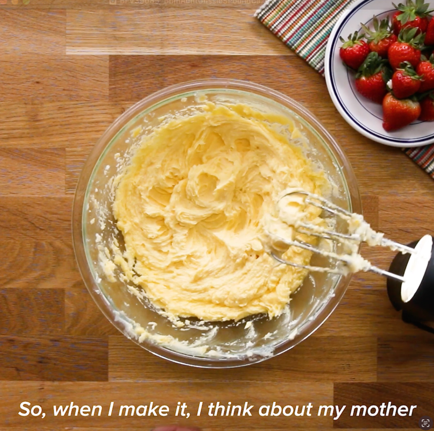Bowl of creamy batter with an electric mixer, next to a plate of strawberries. Text reads: &quot;So, when I make it, I think about my mother.&quot;