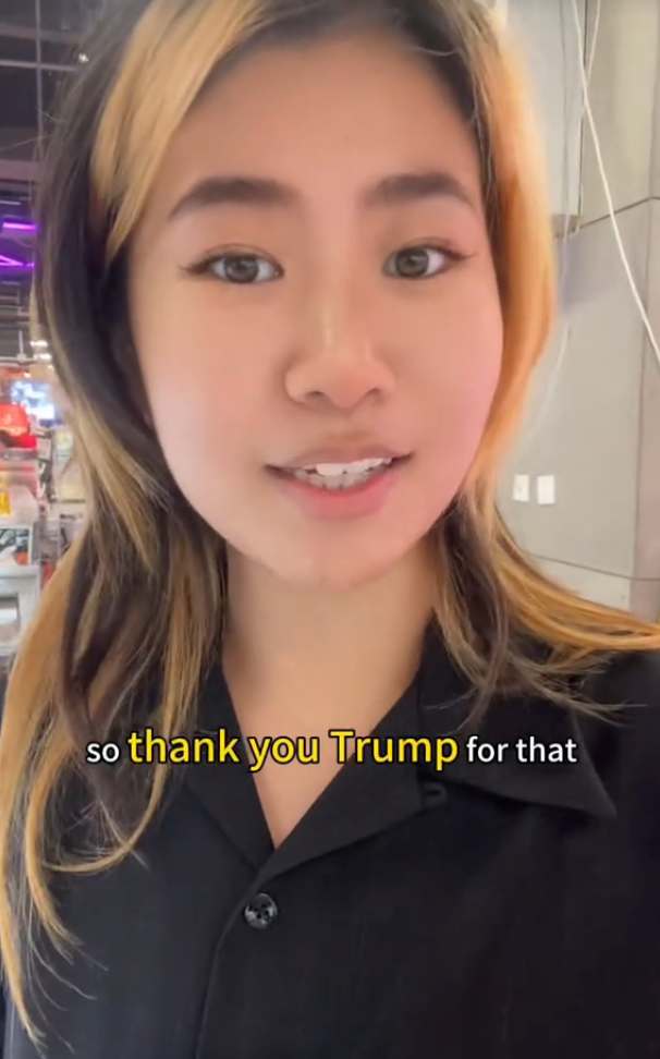 A person in a black shirt speaking, with text saying &quot;so thank you Trump for that.&quot;