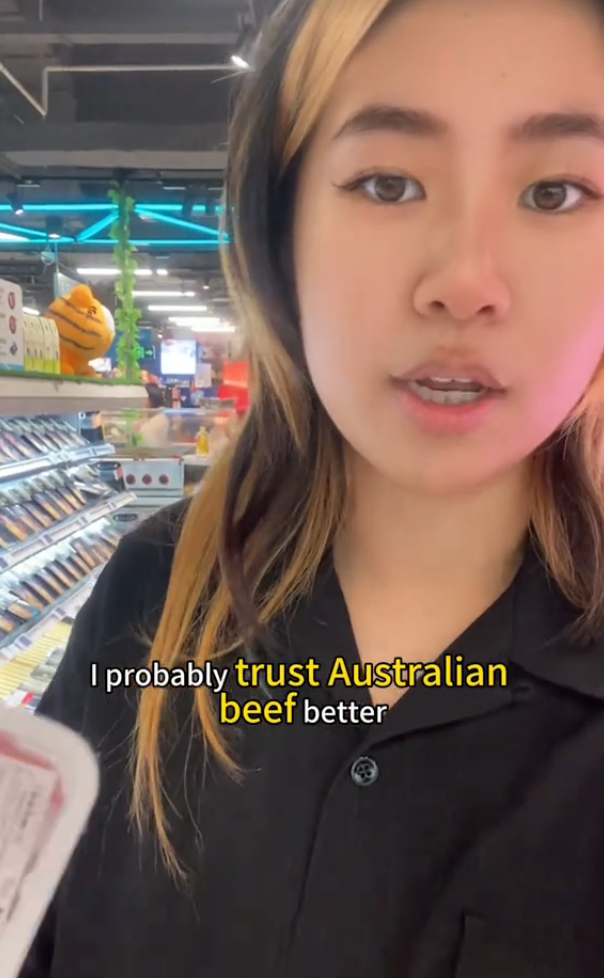 Person in a supermarket holding a packaged item, text reads, &quot;I probably trust Australian beef better.&quot;